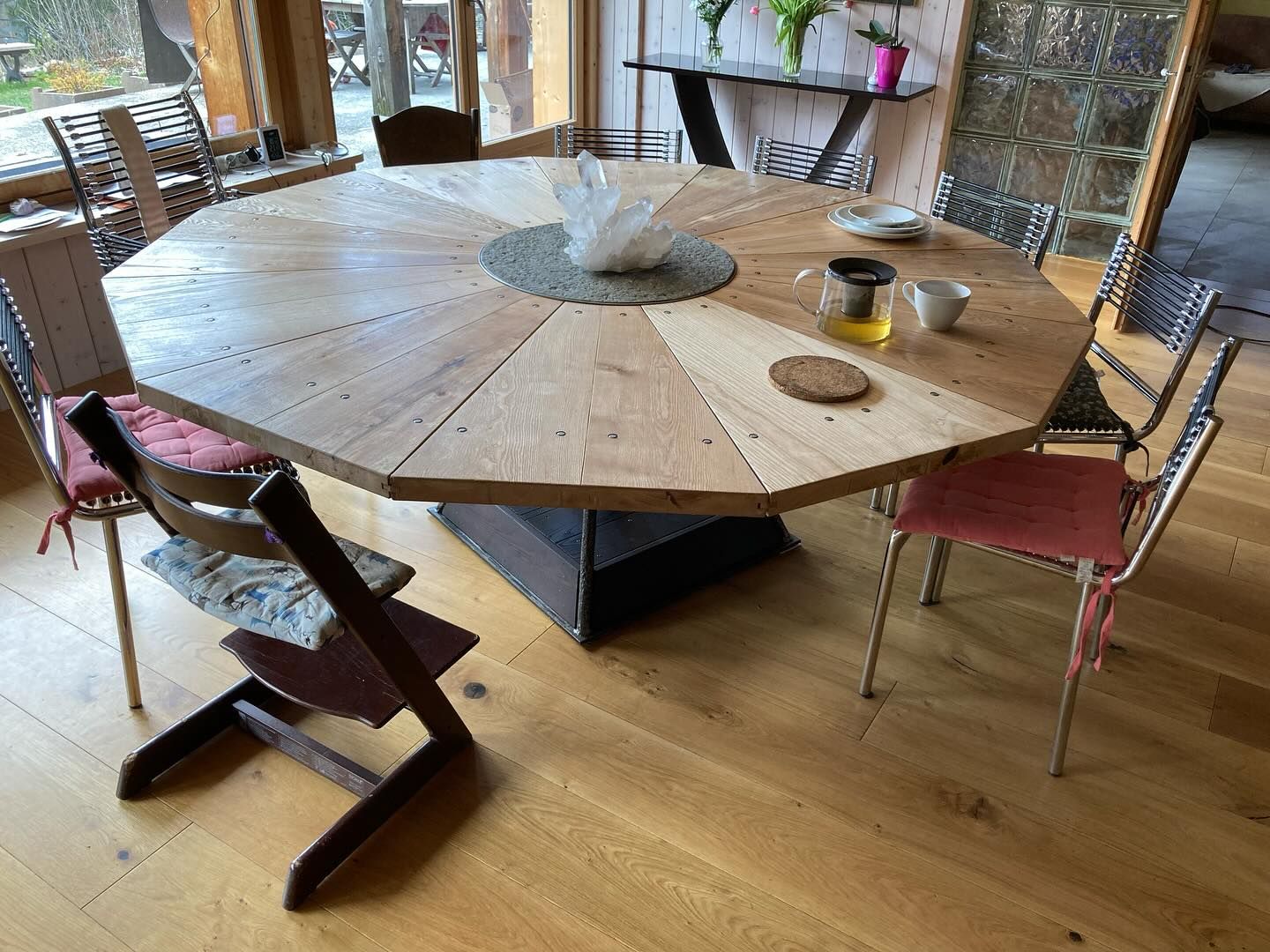 Wooden 10-sided table with a crystal embedded in the middle.